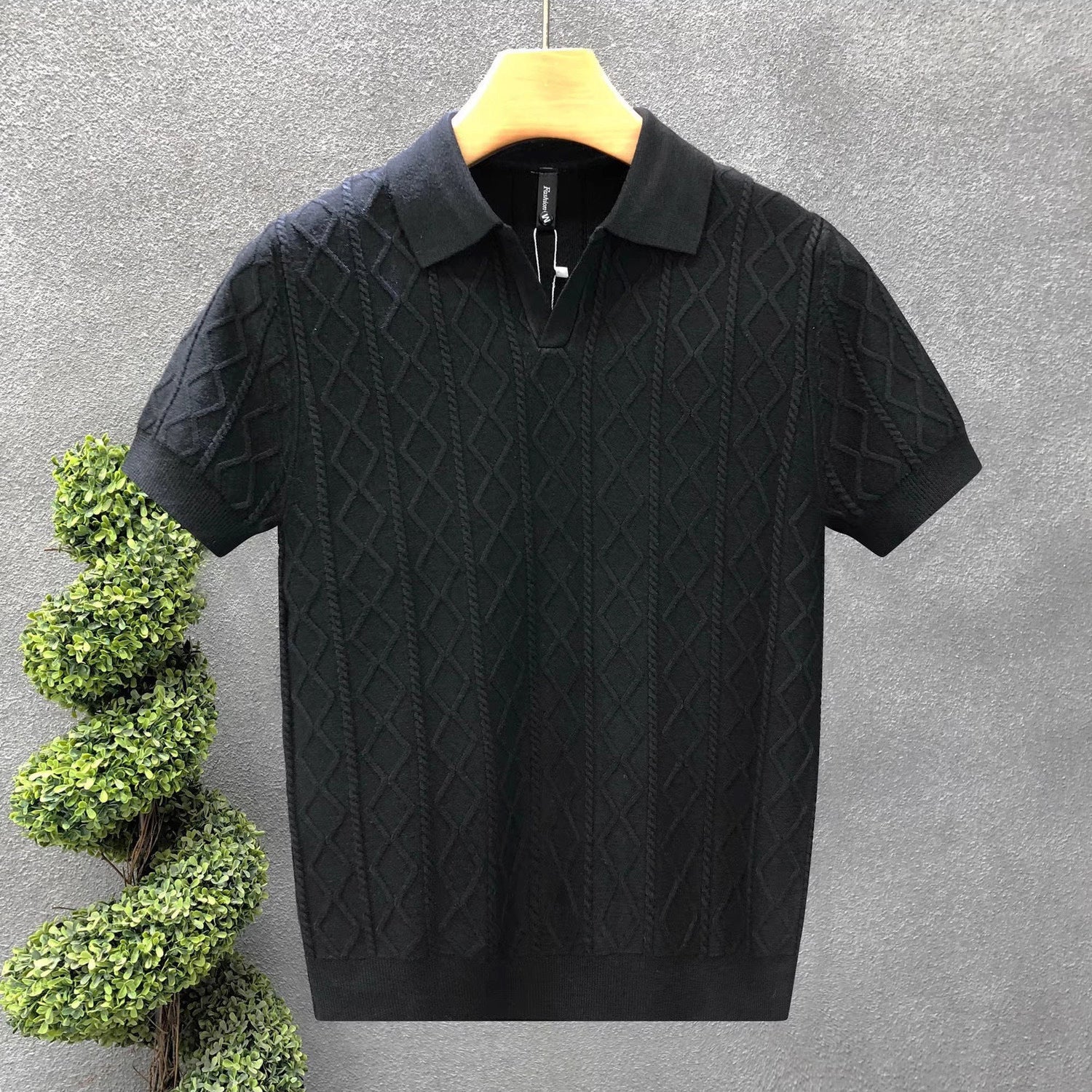 The Whitfield Polo - a richly textured cable-knit polo with a zip placket V-neck